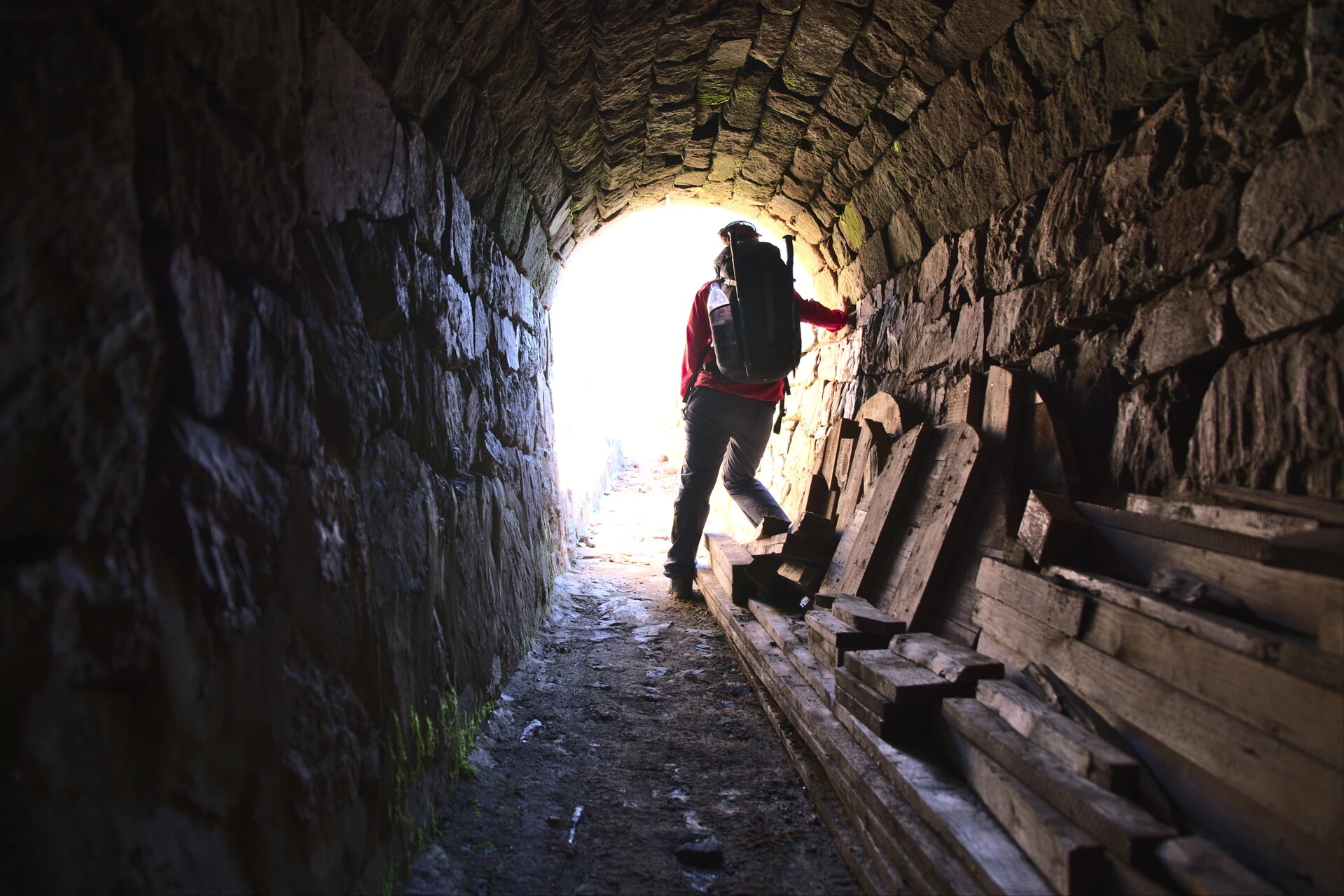 Hiker in a stone-built gallery of the canal de Malcros