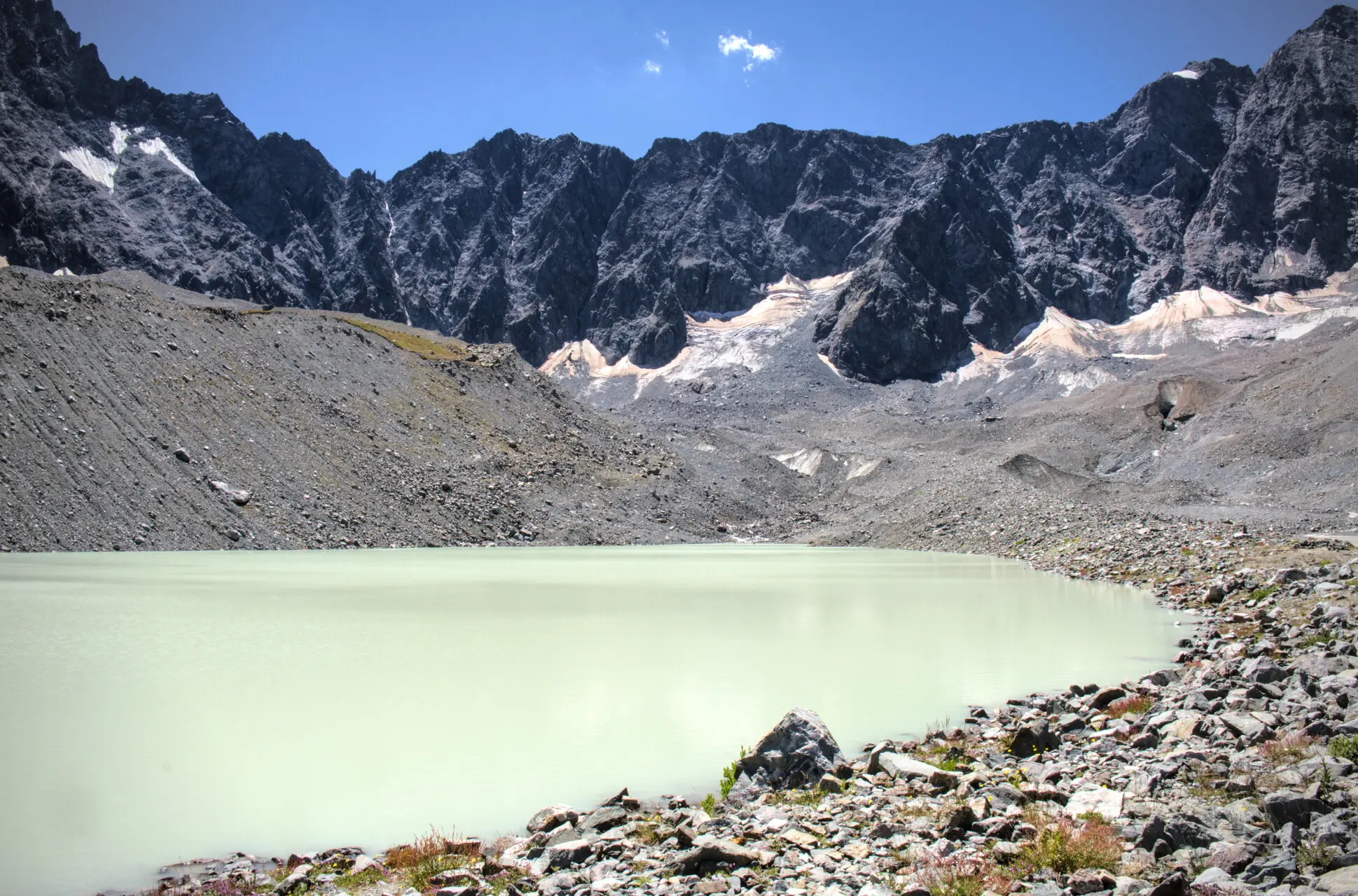 Lac du Glacier d'Arsine and its milky waters, surrounded by moraines and rock walls