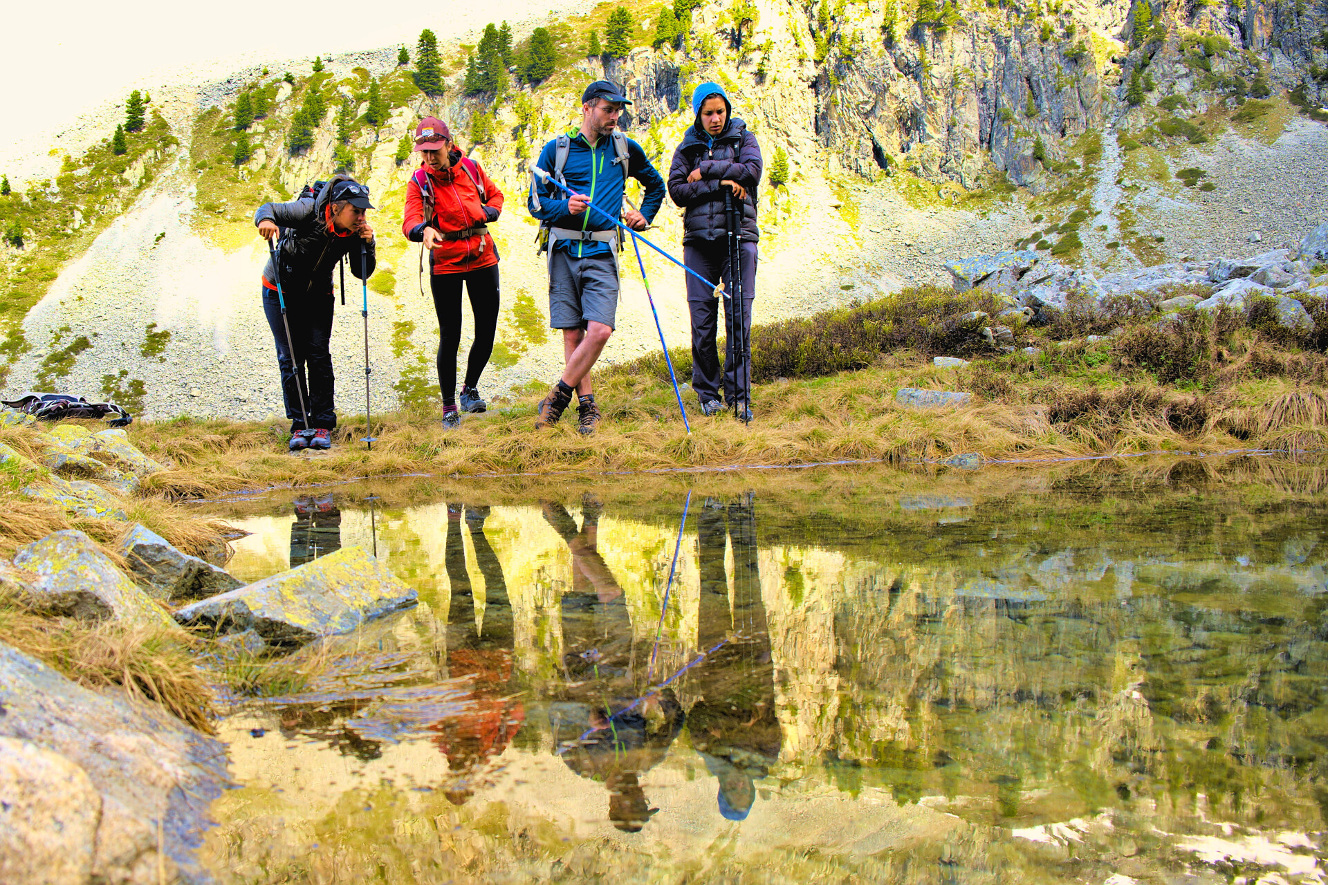 Hikers taking a break beside a mountain lake